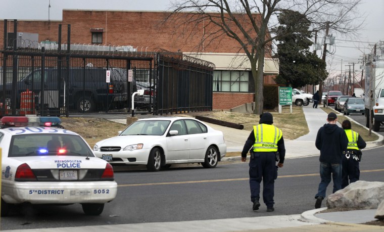 Image: Law enforcement officials are seen near a postal sorting facility