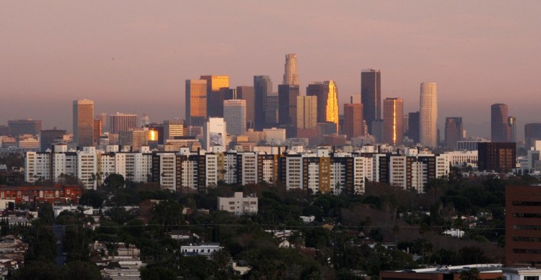 Image: The Los Angeles skyline is shown in the distance as seen from the 15th floor of a hotel in Beverly Hills