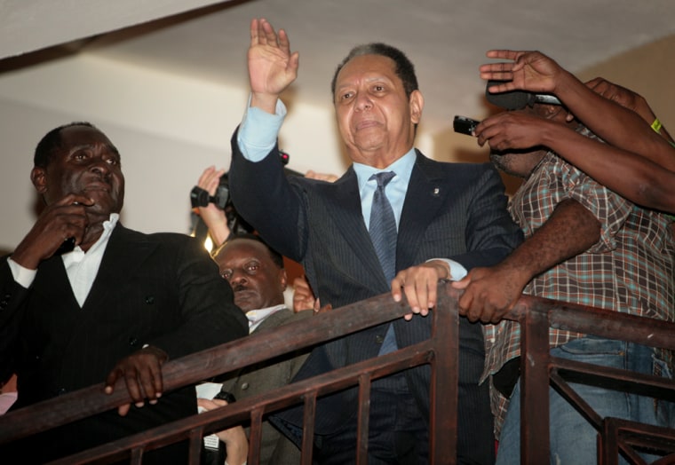 Image: Former Haitian dictator Jean-Claude \"Baby-Doc\" Duvalier waves from a hotel in Petionville