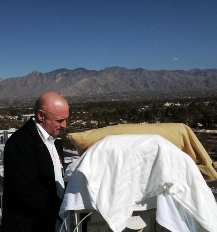 Image: Mark Kelly, stands with his wife Gabriell Giffords