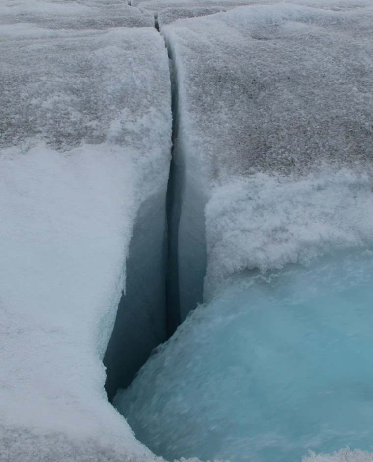 Image: Meltwater flows into Greenland ice.