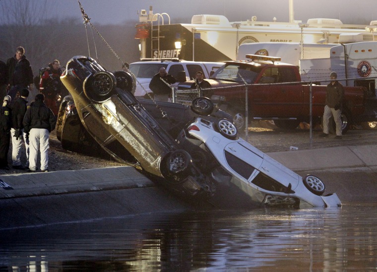 Image: Rescue workers pull up three cars