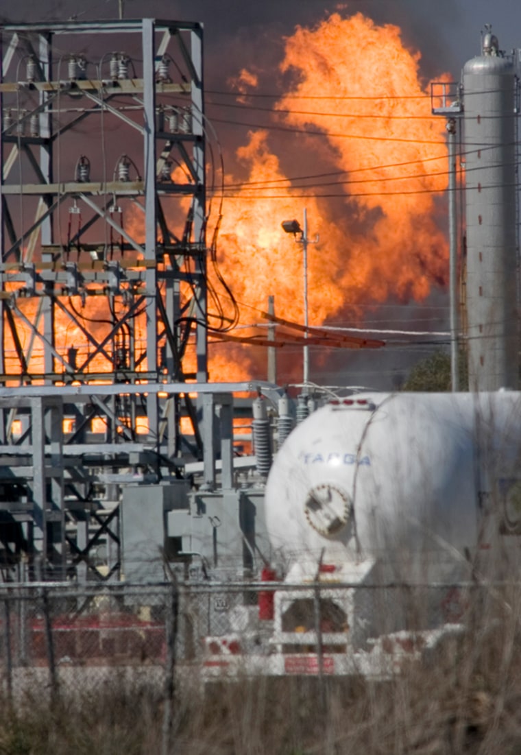 Image: Flames erupt from the Enterprise Products plant after a series of explosions triggered the blaze which burned out of control at the facility