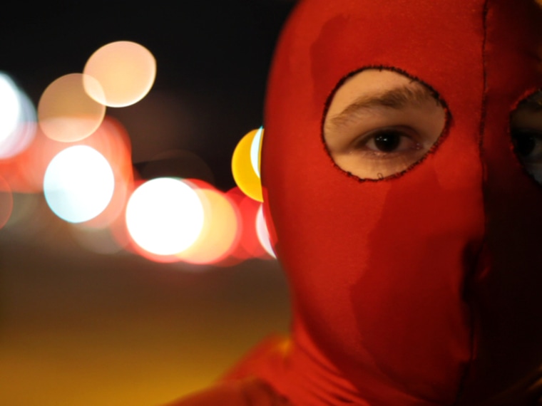 The Vigilante Spider, who has spent 11 years performing acts of goodness around San Diego, is a member of the Real Life Superheroes. The group has nearly 60 members, who don tights, cloaks and cowls to spread the message that 'everybody can make a difference.' Here he's shown in a new documentary, "."