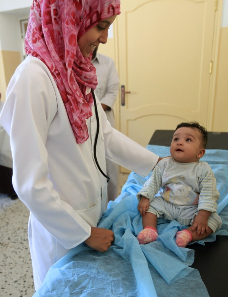 Image: Doctor treats a child at a medical center in Herawa