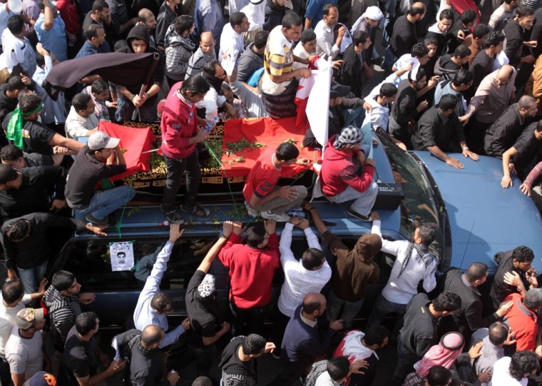 Image: A funeral procession for Ali Abdulhadi Mushaima, 21, moves slowly through the streets of Jidhafs, Bahrain