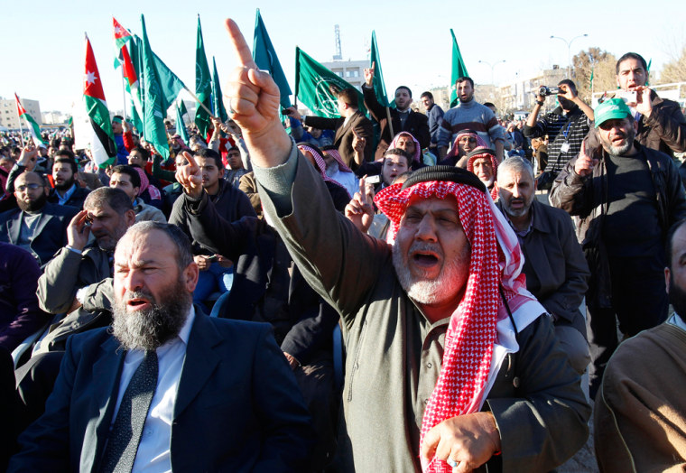 Image: Supporters of the Jordanian Muslim Brotherhood and Islamic Action Front party shout slogans during a rally in Amman
