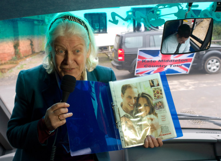 Image: Tour guide Charmian Griffiths holds up a magazine clipping of Prince William and his fiancee Kate Middleton