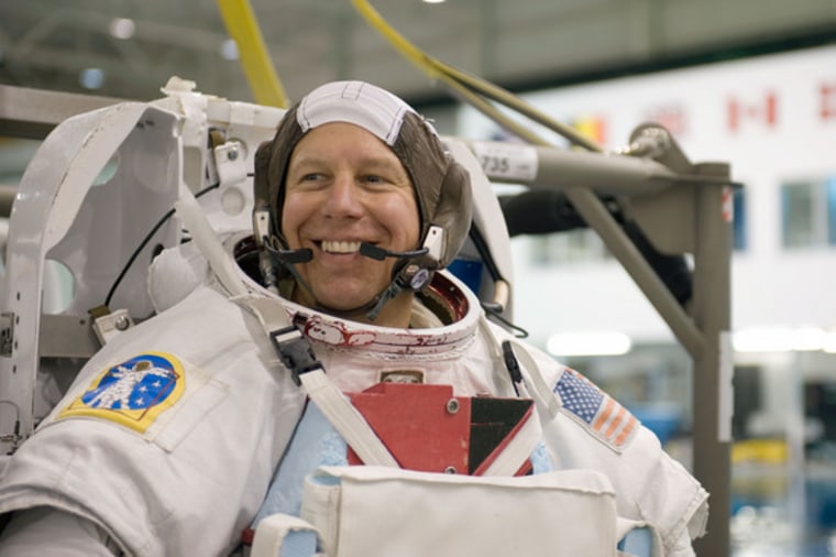 NASA astronaut Tim Kopra is shown during training, attired in a version of his Extravehicular Mobility Unit spacewalking suit. A bicycle accident forced him to miss the last  Discovery flight. 