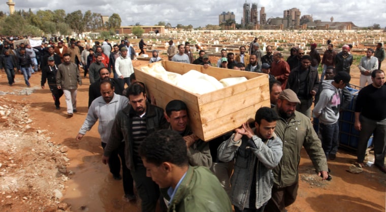 Image: Libyan protesters and relatives carry the coffin with the corpse of protester Esam Bishir Abdo Allah