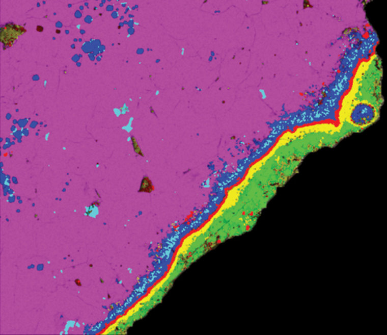False-color compositional X-ray image of the rim and margin of a 4.57 billion-year-old calcium-aluminum-rich inclusion from the Allende meteorite. Analysis of oxygen isotope abundances clued scientists in to the huge distances this chunk of rock traveled while the solar system was forming.