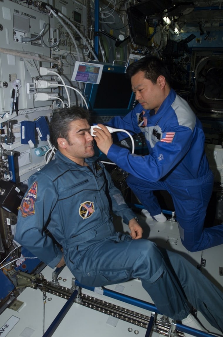 Astronaut Leroy Chiao, commander of International Space Station Expedition 10  (in 2004-05), performs an ultrasound examination of the eye on cosmonaut Salizhan Sharipov.