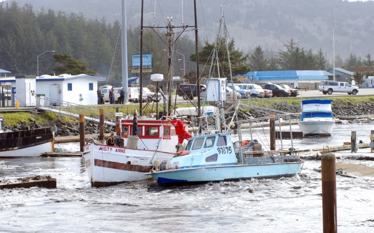 Image: Driven by the force of a tsunami surge, a loose boat slams into another in the boat basin at Crescent City, Calif.