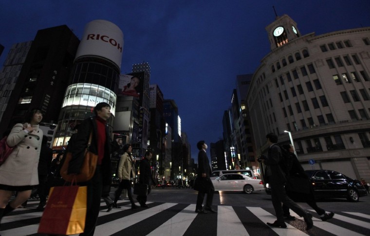 Image: City lights and billboards are turned off in Tokyo