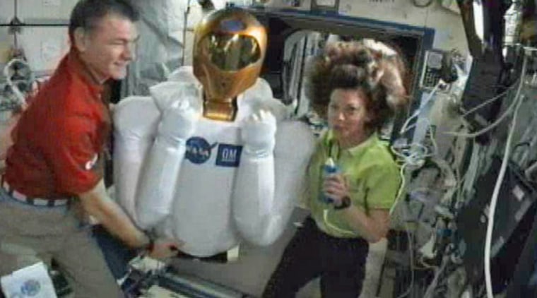 Image: two astronauts with Robonaut 2 bot