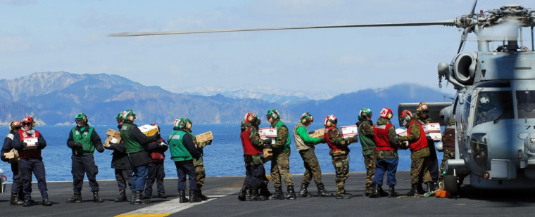 Image: US Navy sailors load humanitarian supplies