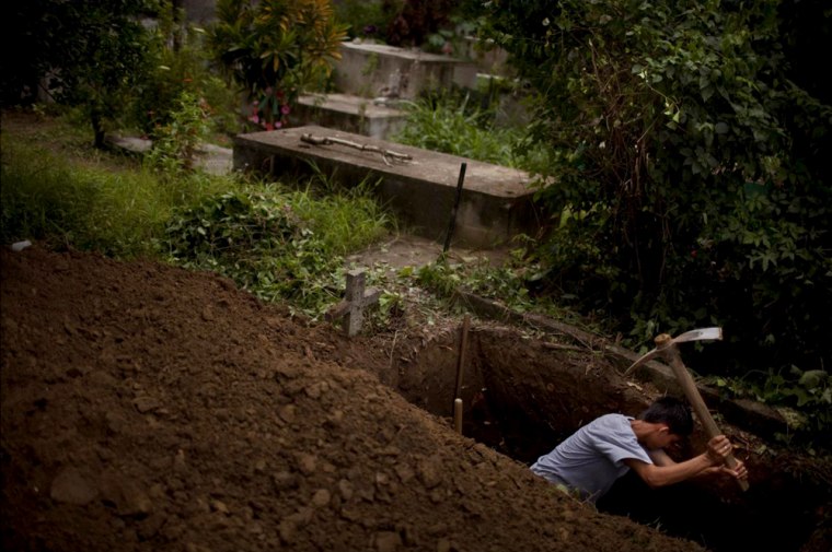 Fernando Ferre, 17, dug the grave of a neighbor who was killed near San Pedro Sula, Honduras.