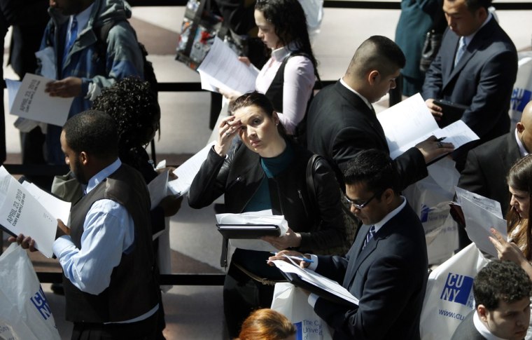Image: People wait in line to enter the City University of New York (CUNY) Big Apple job fair in New York,