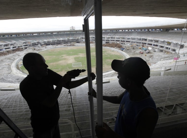 Image: Labourers work during the renovation of the Maracana Stadium in Rio de Janeiro