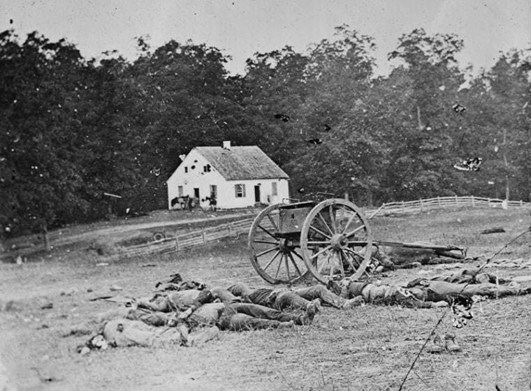 This photograph of a scene in Antietam, Md., was taken by Alexander Gardner, who worked for a time as an assistant to Matthew Brady. Some felt that the bodies were possibly moved in order to keep the church in the background.
