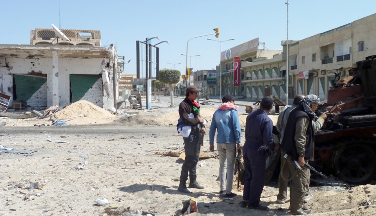 Image: Libyan rebel fighters are seen on Tripoli Street in the strategic western rebel-held port of Misrata