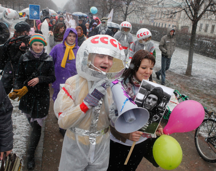 Image: People participate in a flashmob rally to mark the 50th anniversary of Yuri Gagarin's mission