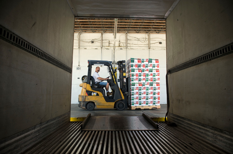 Image: Forklift operator Daniel Crothers of West Coast Tomato, prepares to load a truck with produce at the company's facility in Palmetto, Fla.