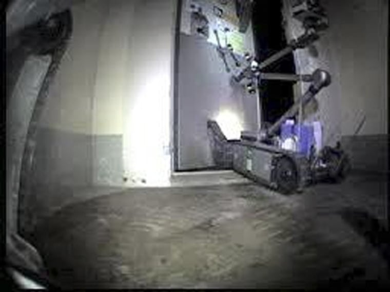 Image: A remote-controlled robot called \"Packbot\", opens the door at Tokyo Electric Power's crippled Fukushima Daiichi Nuclear Power Plant No.3 reactor in Fukushima, northern Japan