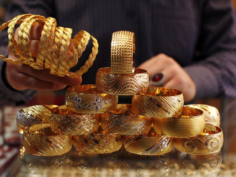 Image: A goldsmith displays gold bangles in his jewellery shop in Istanbul