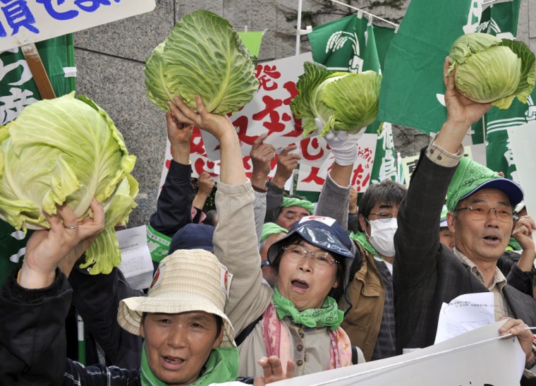 Image: Farmers hold cabbages to protest against the Japanese nuclear accident at the headquarters of the Tokyo Electric Power Co (TEPCO) in Tokyo on April 26.