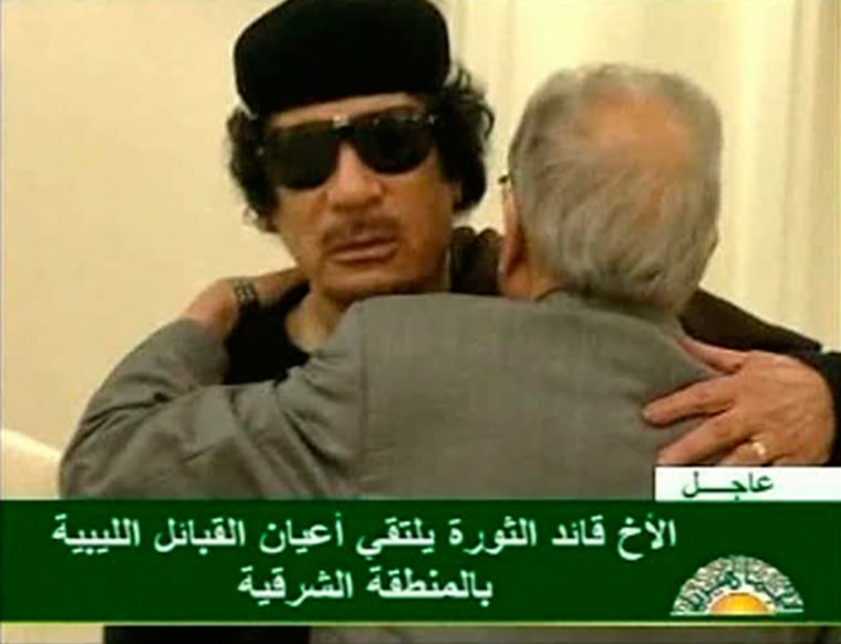 Image: Still image from a video shows Gaddafi greeting an official in a Tripoli hotel