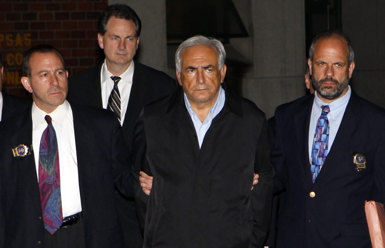 Image: Dominique Strauss-Kahn, head of the IMF, departs a New York Police Department precinct in New York