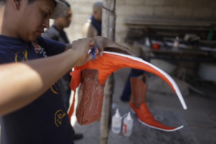 Image: Young men create their own pointy boots that they will use at a dance competition in Matehuala, Mexico.