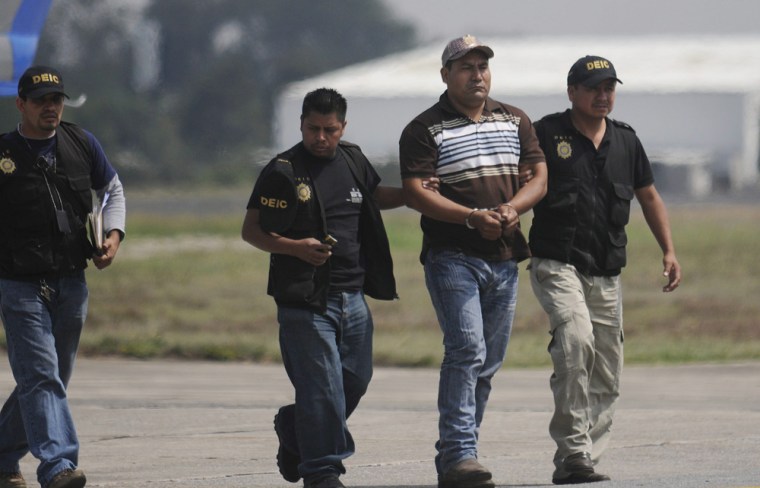 Image: Police detained allegedly imputed in the killing of 27 farmworkers in Guatemala