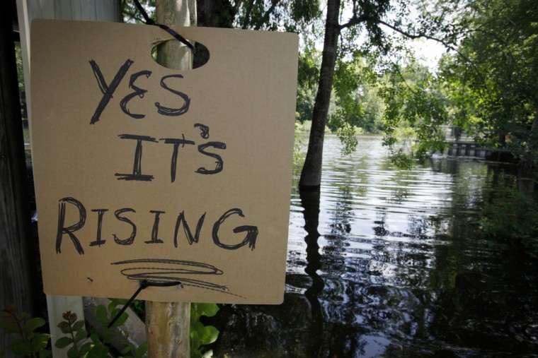Image: Sign informs passers-by of rising water in Butte LaRose, Louisiana
