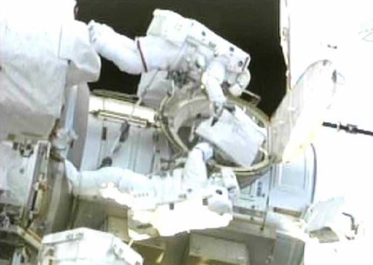 Image: Space shuttle Endeavour astronauts Drew Feustel and Mike Fincke exit the Qwest airlock at the beginning of their spacewalk in this image by NASA TV
