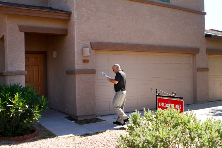 Image: Jayson Meyerovitz, a broker who is concerned about bank-owned foreclosures, looks at a bank-owned home in Surprise, Ariz.