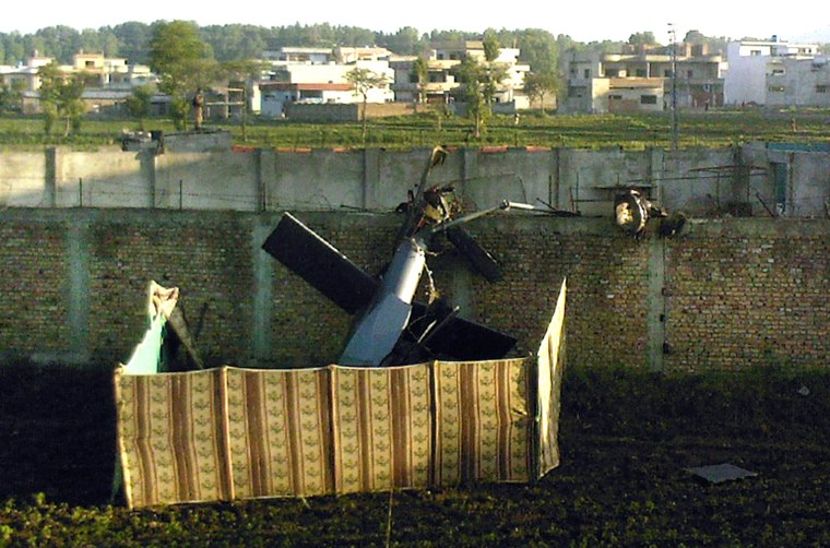 Image: crashed military helicopter is seen near the hideout of Al-Qaeda leader Osama bin Laden