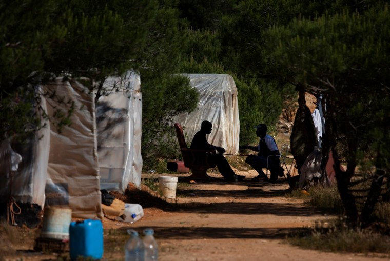 Image: Sub-saharan immigrants in an encampment near near Palos de la Frontera.