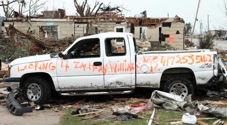 Image: A message painted on the side of a truck damaged in the Joplin, Mo., tornado asking for help finding Zachary Williams, 12.