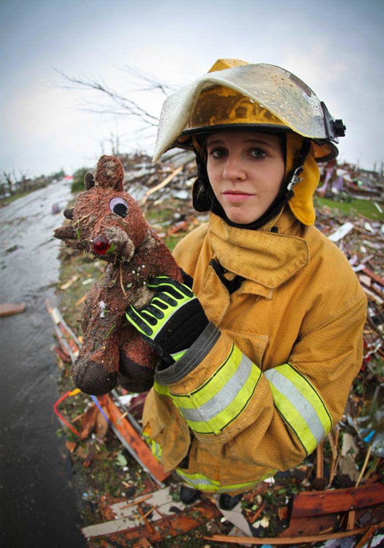 Jill Duggar, holds a stuffed animal uncovered while volunteering with search and rescue operations on Monday, May 23, 2011. Following the massive tornado that ripped through the town of Joplin, MO, Jill and several of her siblings traveled from their Arkansas home to help. JIll was part of a large group of firefighters that came to the area to help aid local emergency teams. Jill is part of the Duggar Family from TLC's 19 Kids & Counting.