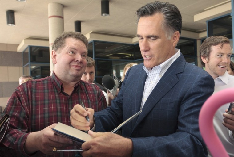 Image: Former Massachusetts Governor Mitt Romney signs autograph for supporters during the Greater Des Moines Partnership's Presidential Forum Speaker Series