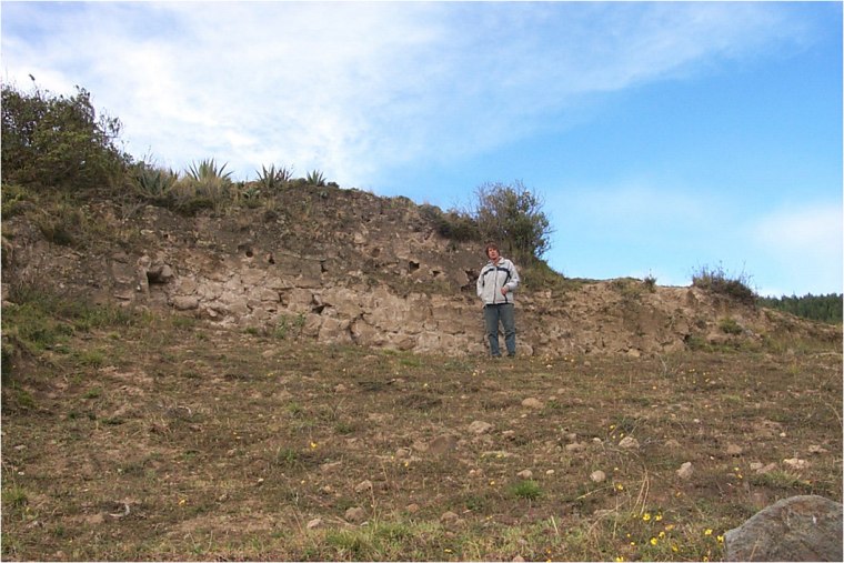 This has been tentatively identified as a Cayambe fortress, built to defend their lands. It was constructed with a hard volcanic material called Cangahua. The fort would have been a massive structure 500 years ago with people living both inside and outside its walls. Samuel Connell, a director of the excavation, is shown alongside it for scale. Photo courtesy Samuel Connell/Pambamarca Archaeological Project