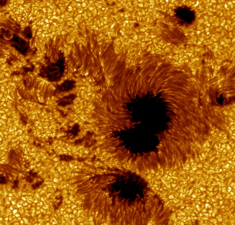 This large field-of-view image of sunspots in Active Region 10030 was observed on July 15, 2002. The relatively cool dark regions have temperatures of thousands of degrees Celsius, in contrast to the bright glowing gas flowing around the sunspots, which have a temperature of over 1 million degrees Celsius. (Researchers colored the image yellow for aesthetic reasons.)