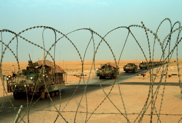 Image: A column of U.S. Army Stryker armored vehicles cross the border from Iraq into Kuwait Wednesday, Aug. 18, 2010