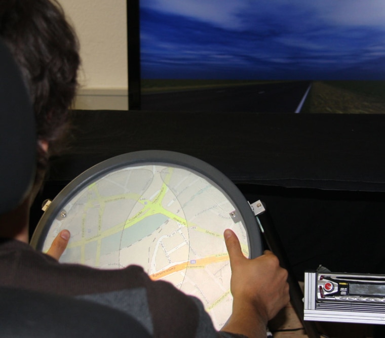 Image: A touch-screen steering wheel prototype that lets drivers control settings with their thumbs.