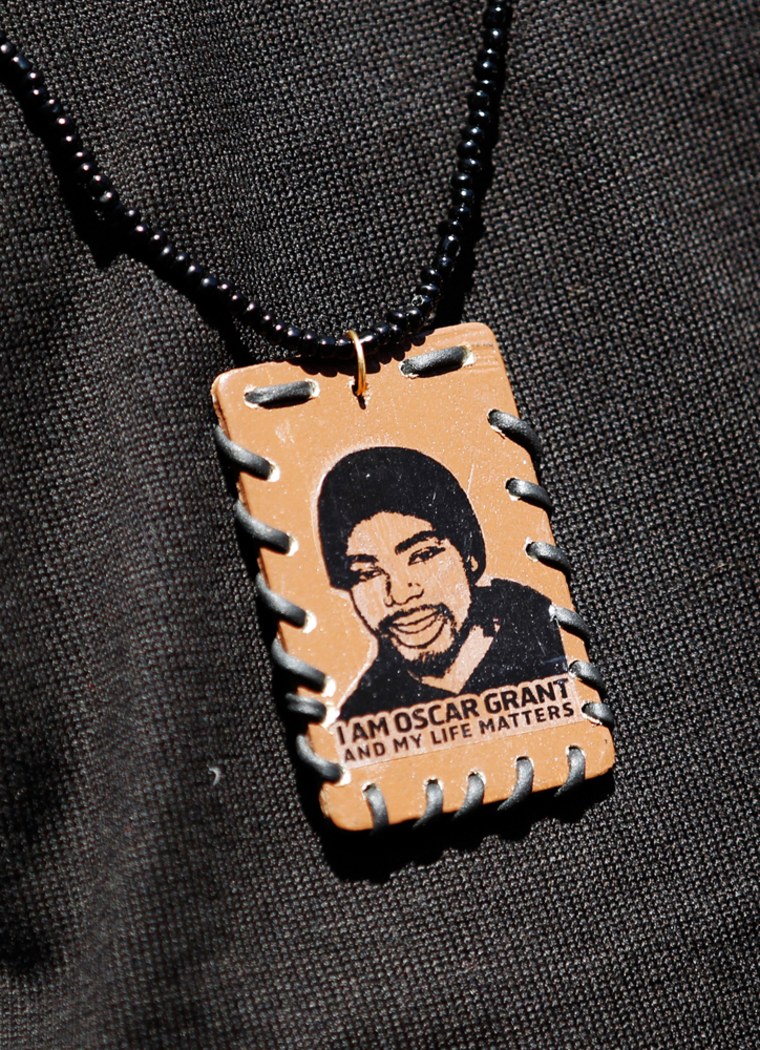 Image: A participant wears a necklace in honour of Oscar Grant during a protest against the upcoming release of Johannes Mehserle, in Oakland