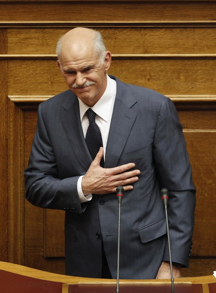 Image: Greece's PM Papandreou bows during a PASOK parliamentary group meeting at the parliament in Athens