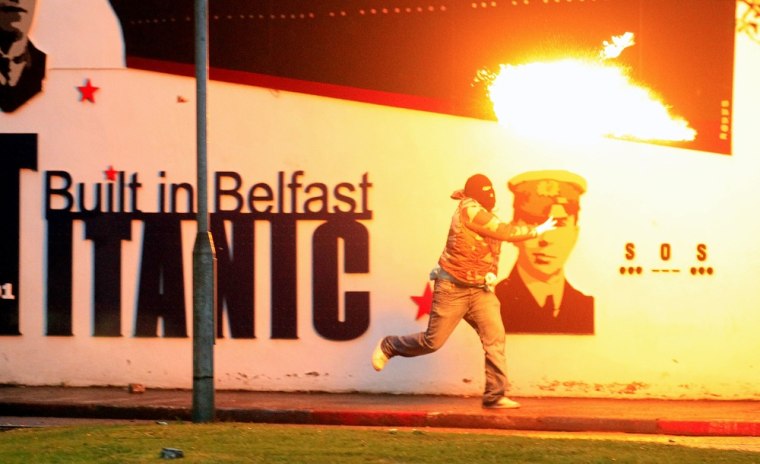 Image: Loyalist rioters throw petrol bombs towards the mainly Catholic Short Strand area of East Belfast