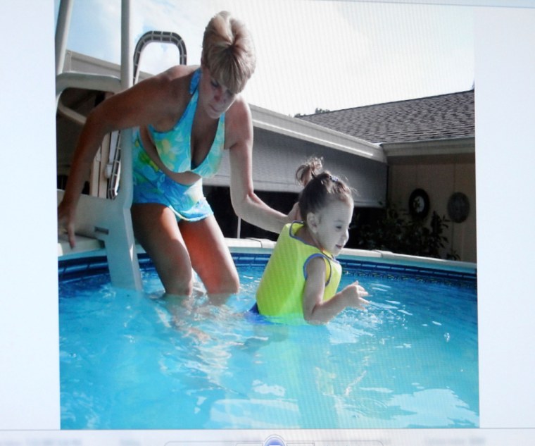 Image: An image projected on a courtroom monitor shows Cindy Anthony with her granddaughter Caylee in a swimming pool in Orlando